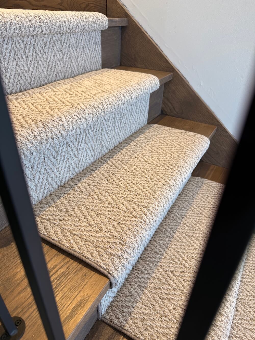 Staircase with textured carpeted steps in a home setting