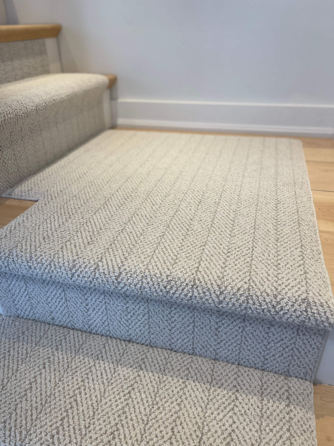 Full view of Amalfi Carrara Herringbone Stair Runner Landing Canada in gray and white tones