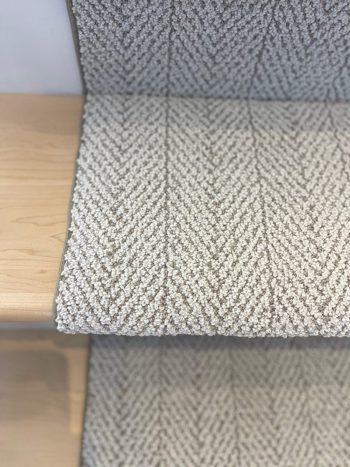 Close-up texture of Amalfi Paradise Modern Herringbone Stair Runner showing beige and ivory weave