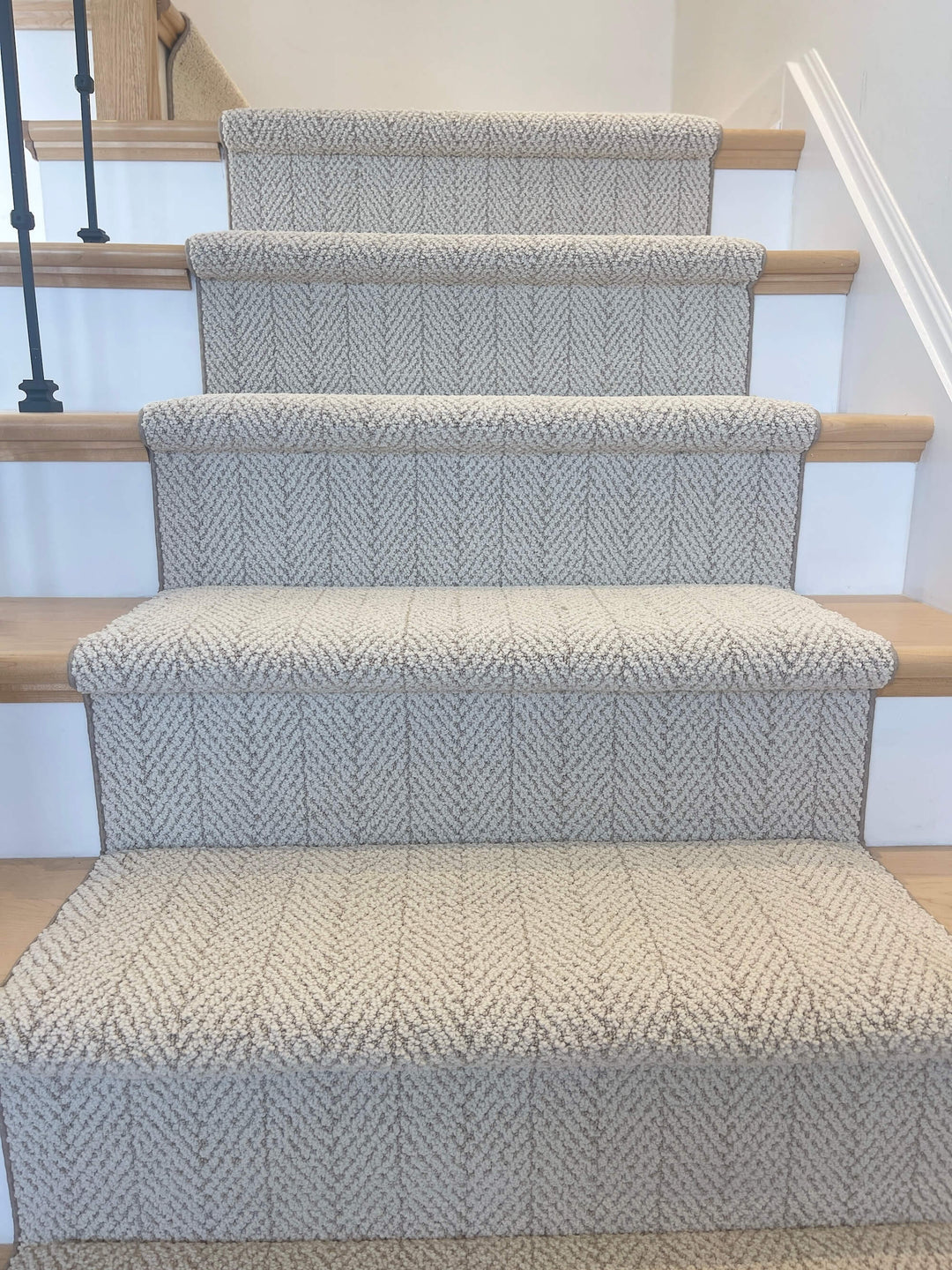 Full staircase view of Amalfi Spartis Herringbone Stair Runner in beige and ivory