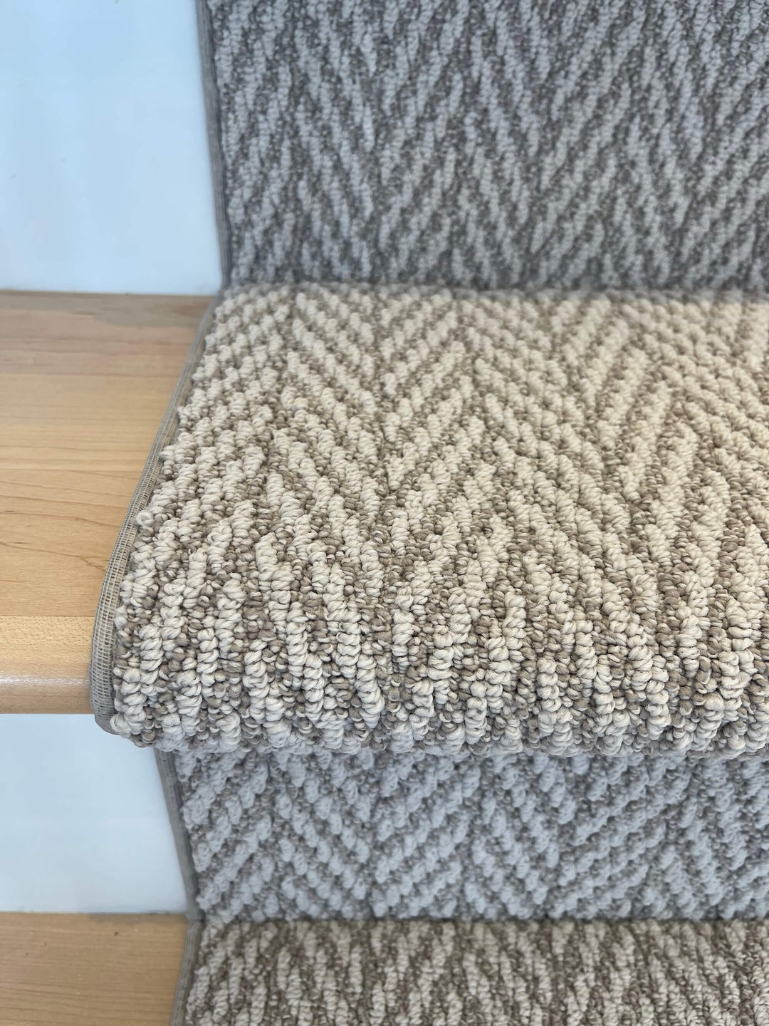 Full staircase view of Anderson Tuftex Fossil Herringbone Stair Runner Canada in taupe-gray tones