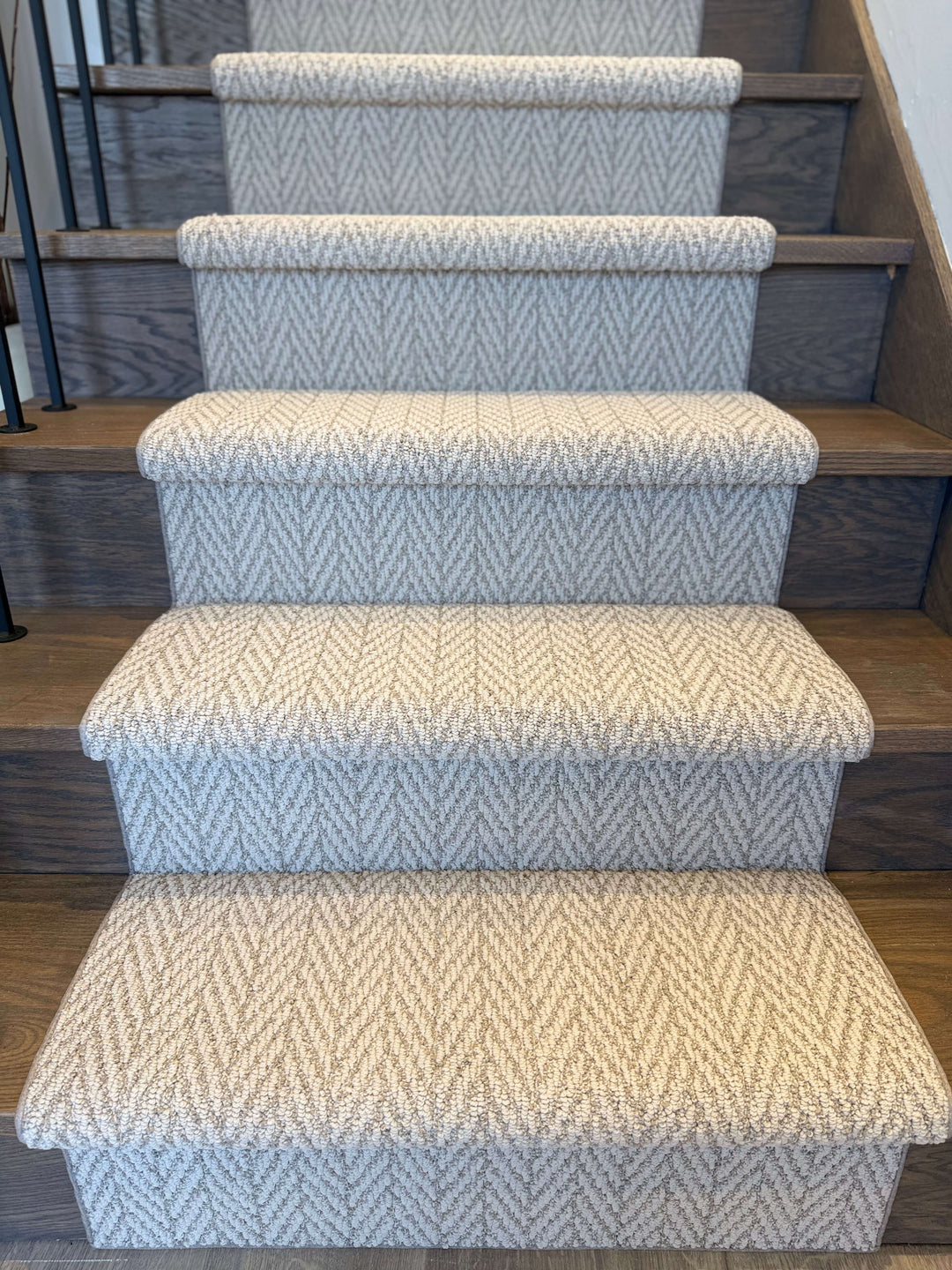 Staircase with patterned carpet runners on wooden steps