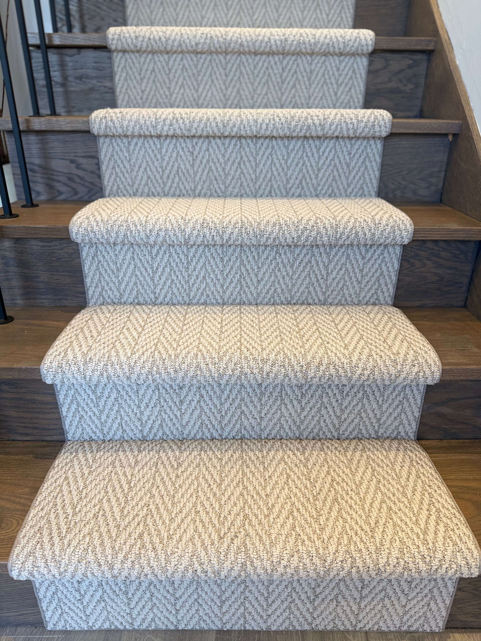 Staircase with patterned carpet runners on wooden steps