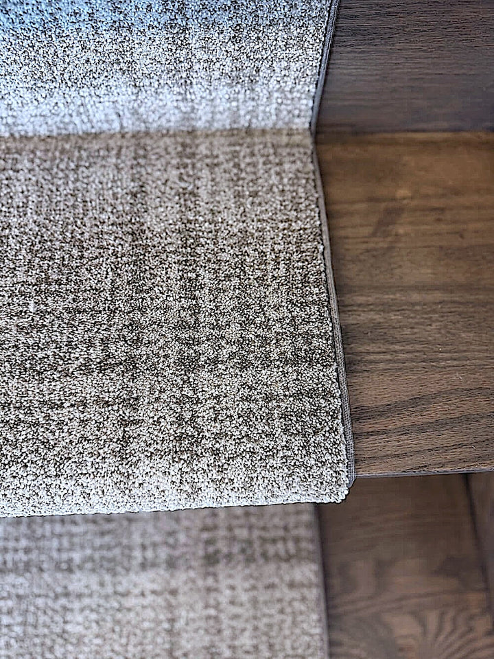 Tartan eclipse stair runner installed on wooden stairs