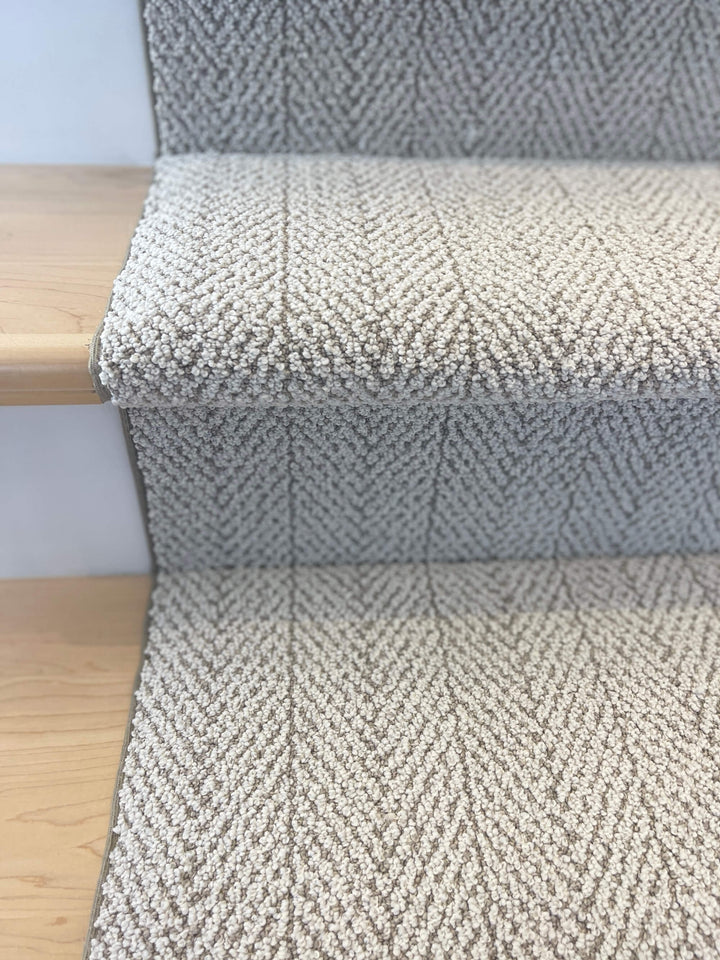 Side view of Amalfi Paradise Modern Herringbone Stair Runner on wooden stairs